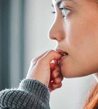 Close-up of woman biting her fingernails